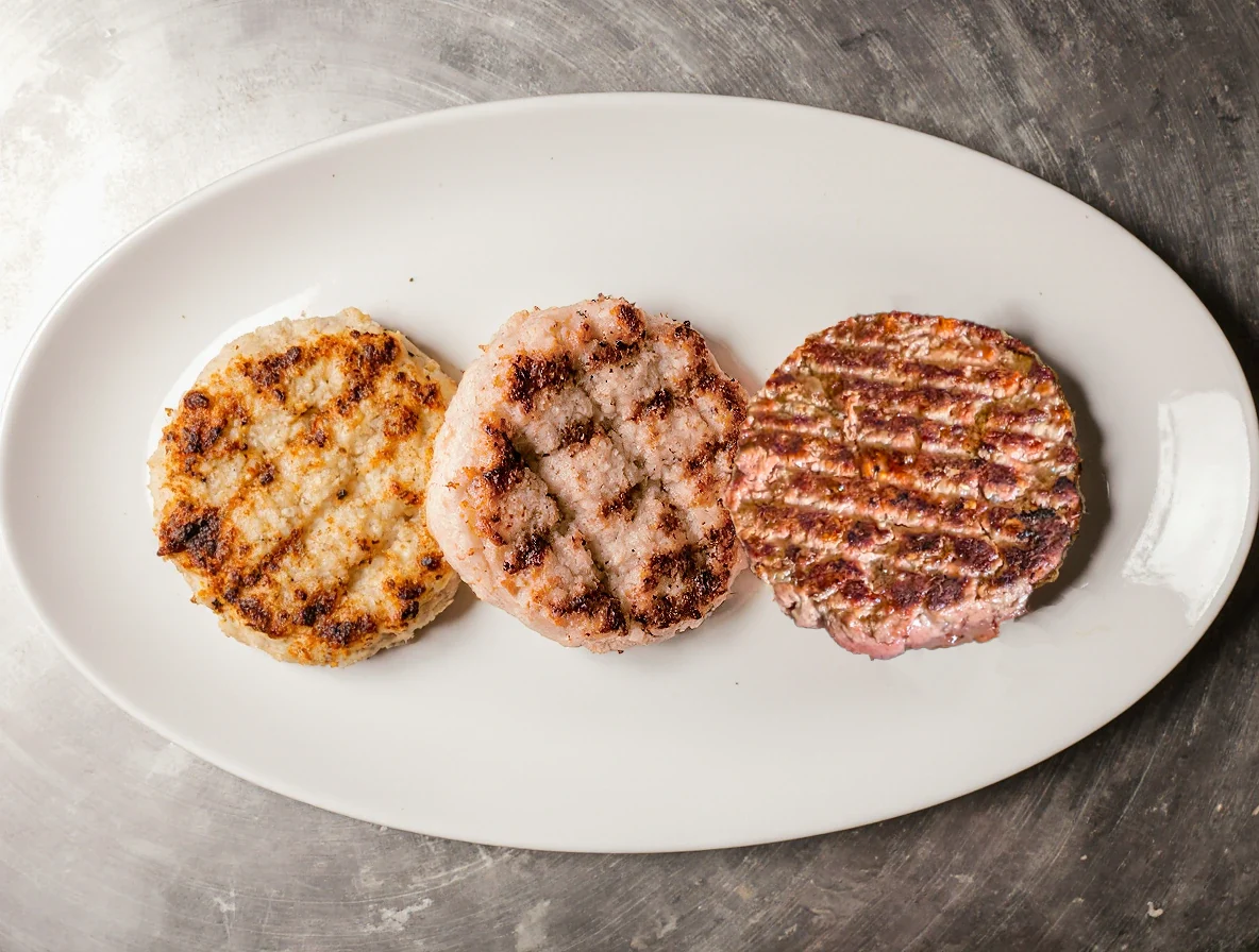 Cooked Plantagusto hybrid patties: chicken on the left, pork in the centre and beef on the right